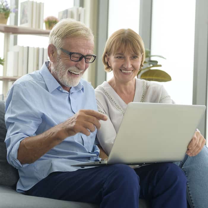 Couple smiling at computer