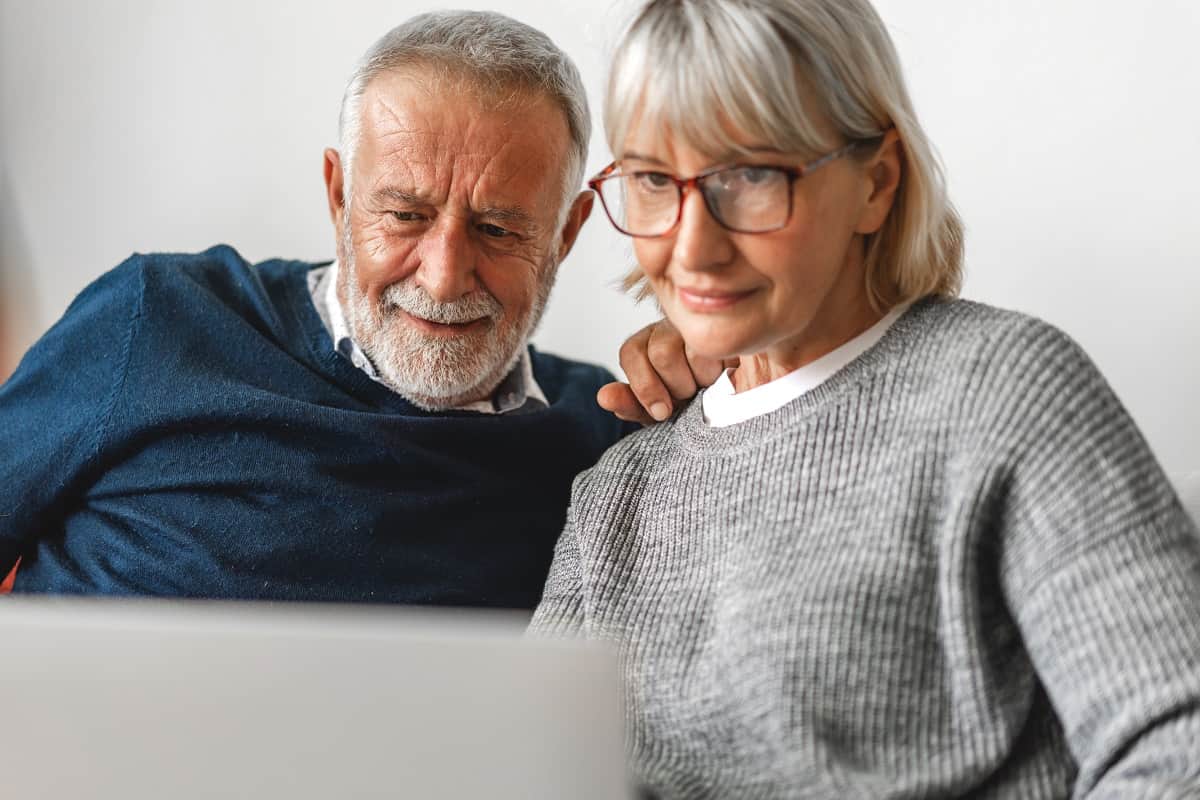 senior couple looking at laptop